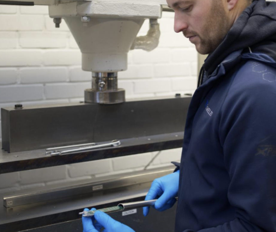 MD Tom McMillan inspects a newly formed 20x12.5x1.5mm D-shaped tube