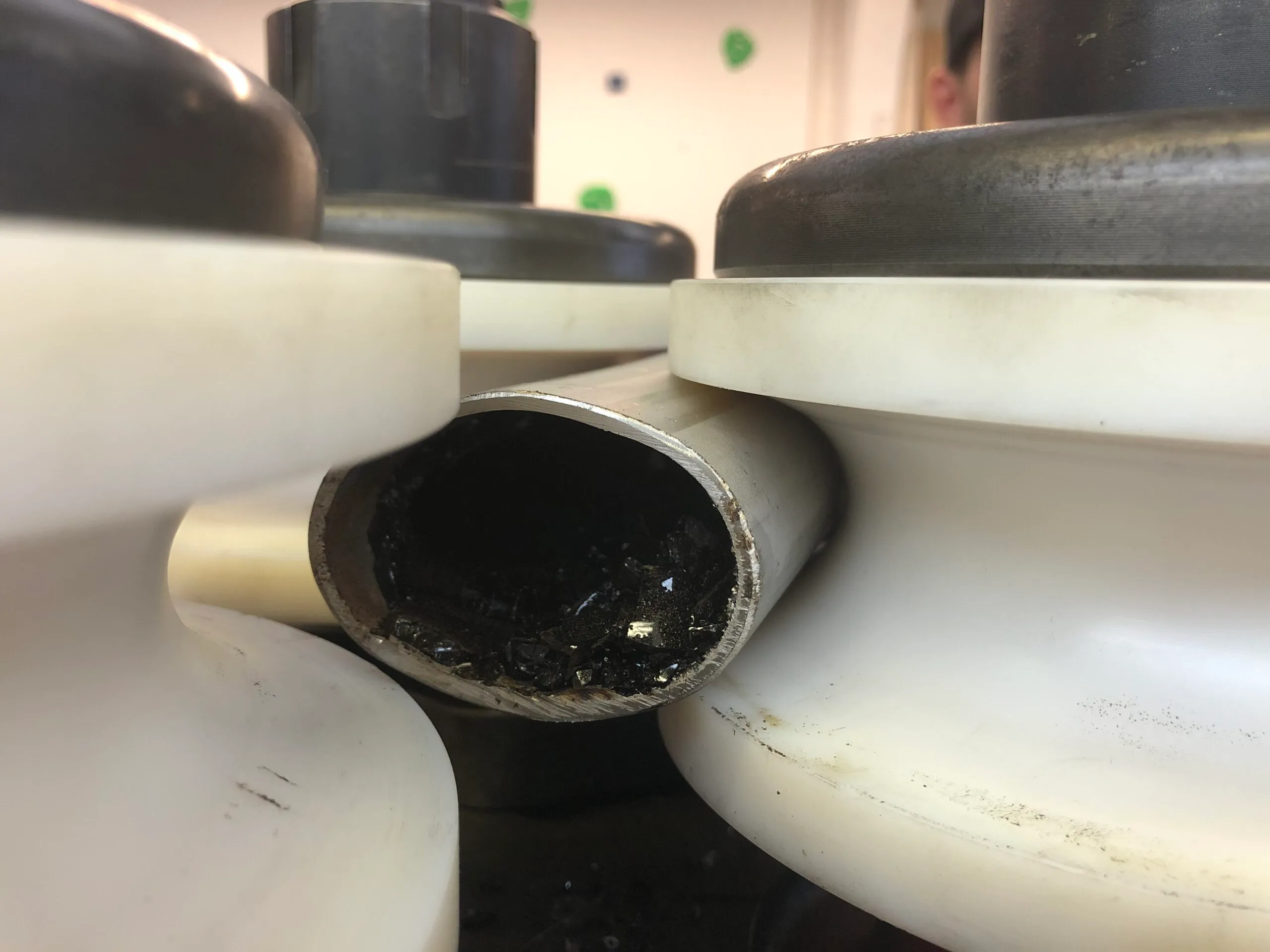 oval metal tubing being mounted into nylon rollers for bending into bespoke shapes