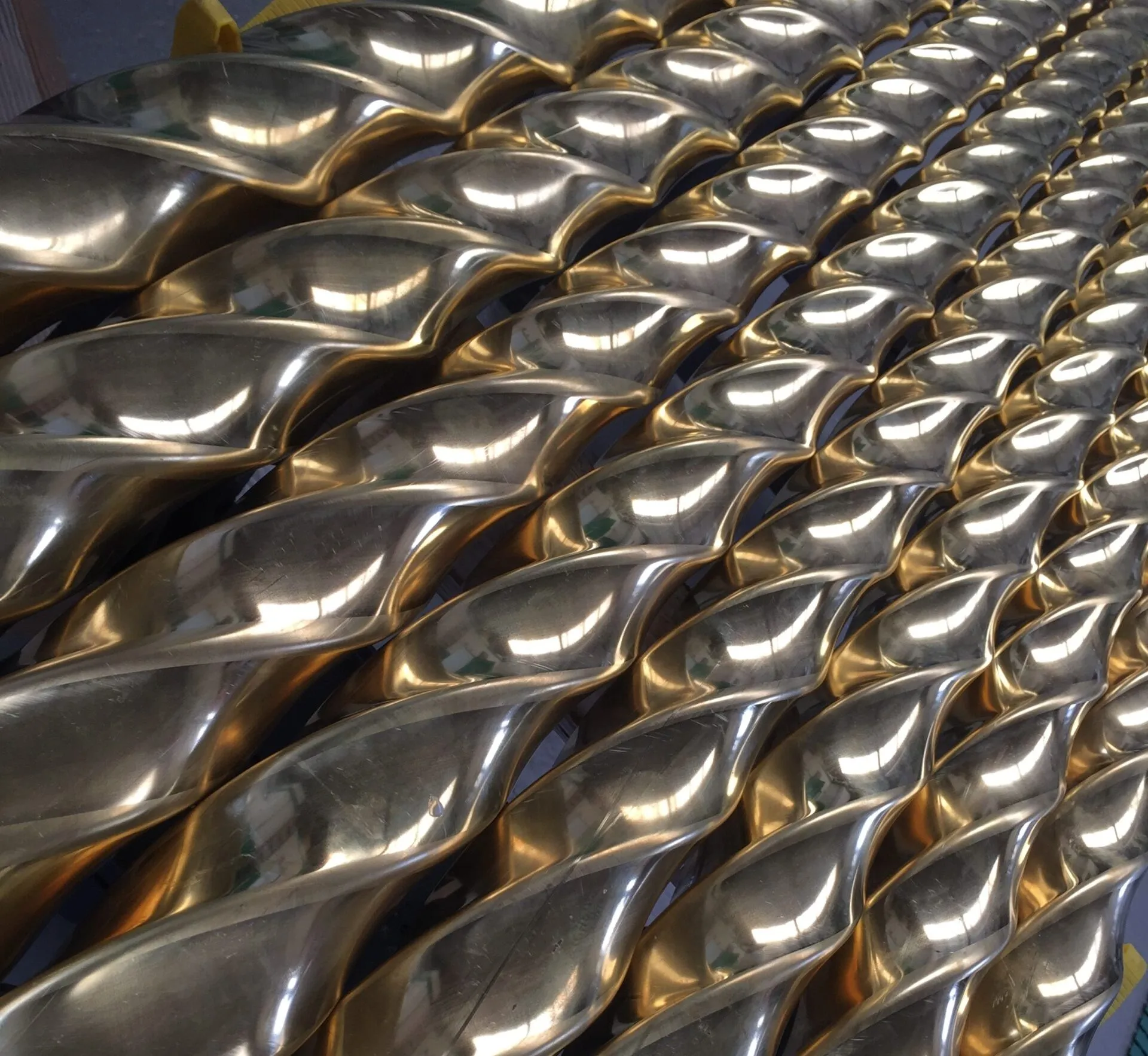 Multiple lengths of mirror polished brass twisted square tube