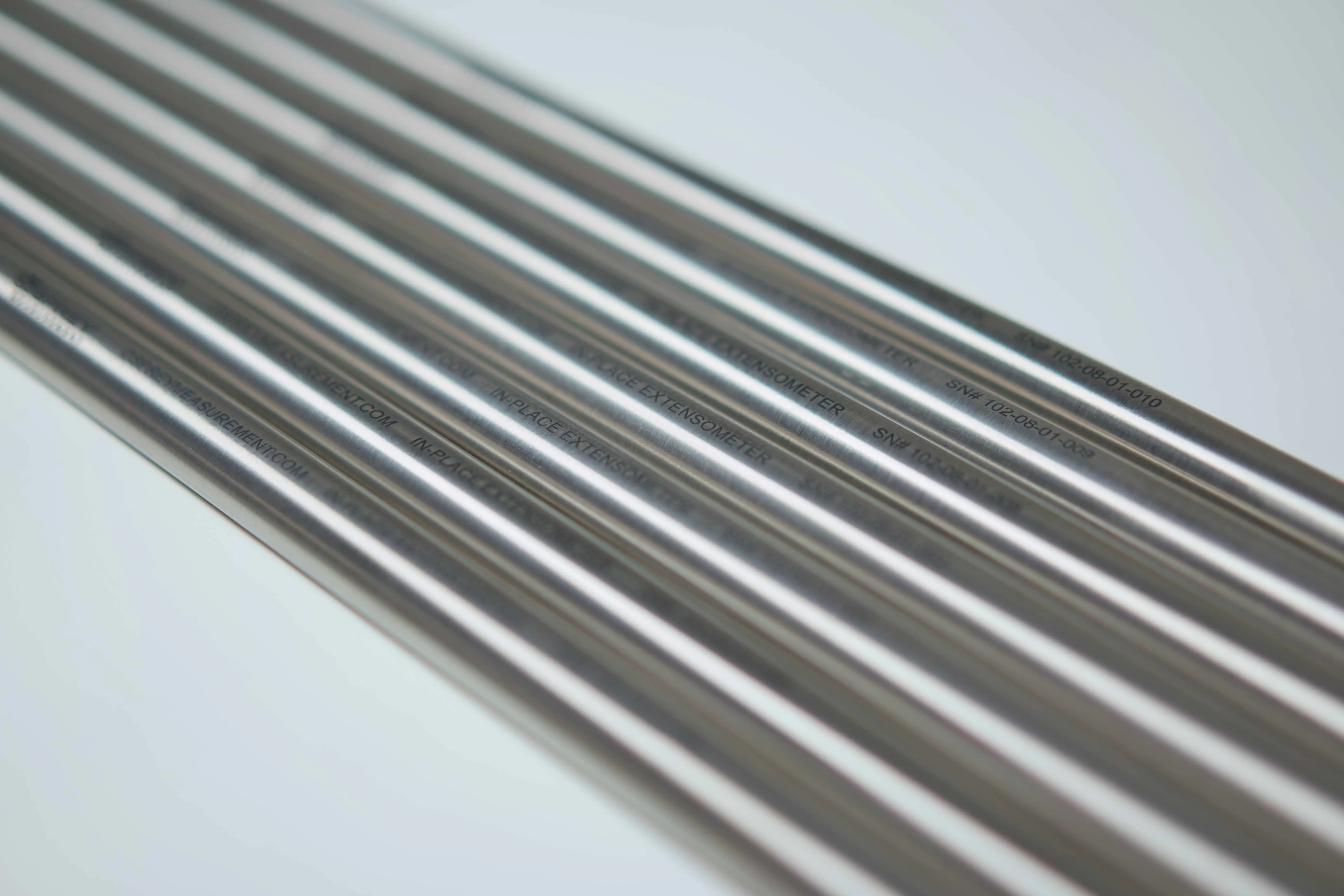 multiple lengths of d-shaped stainless steel tubing with laser etching on the outside