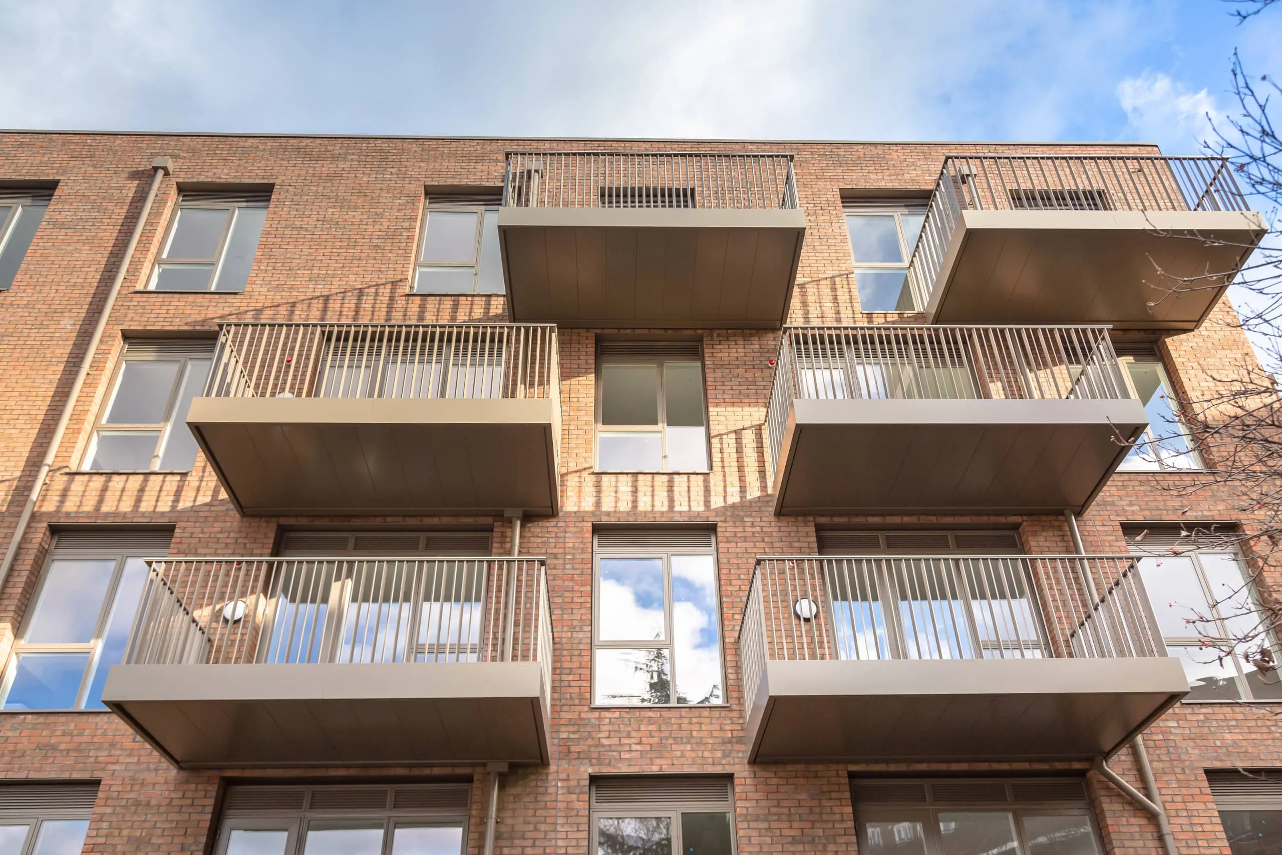 Apartment balconies with stainless steel d-shaped tubing used for handrails