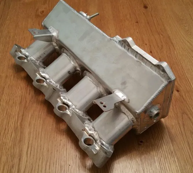 stinaless steel flat-sided oval tubing being used as part of an automotive engine