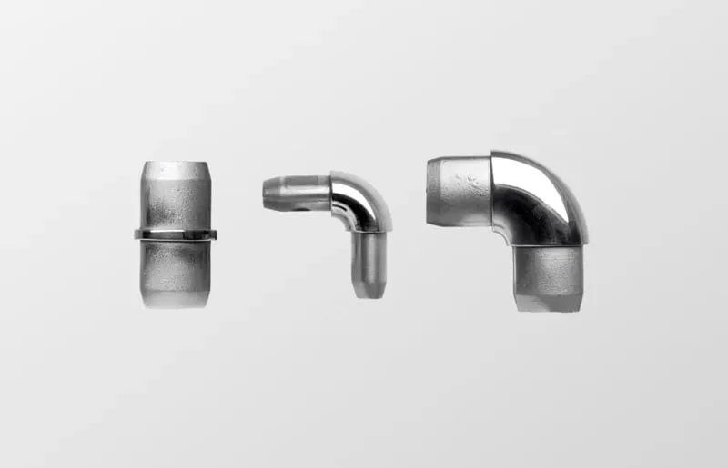 three polished stainless steel tube joiners