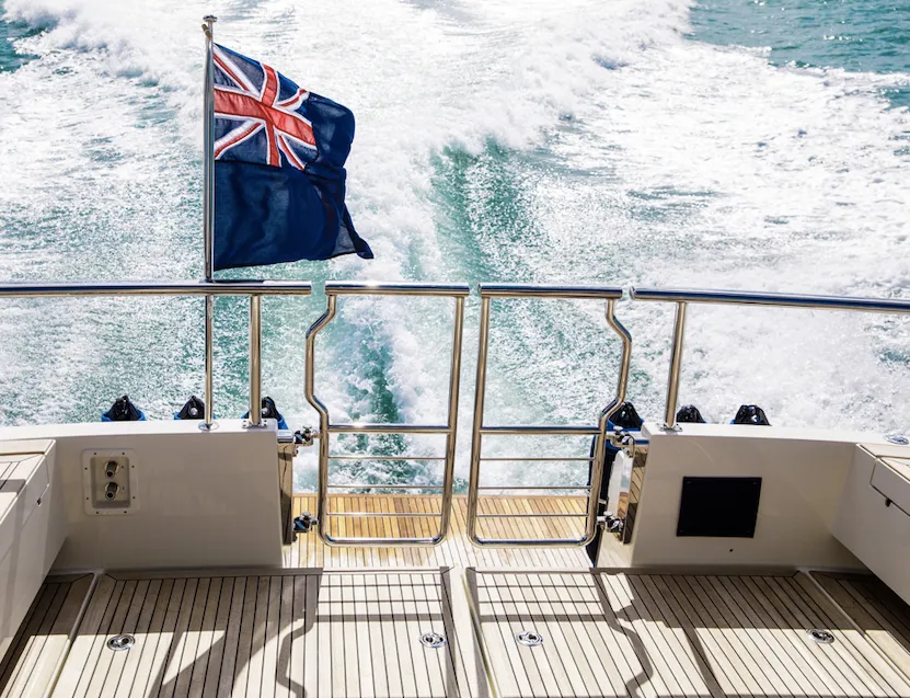 Oval shaped tubing with a mirrored finish being used for handrails and hinged gates on the stern of a boat